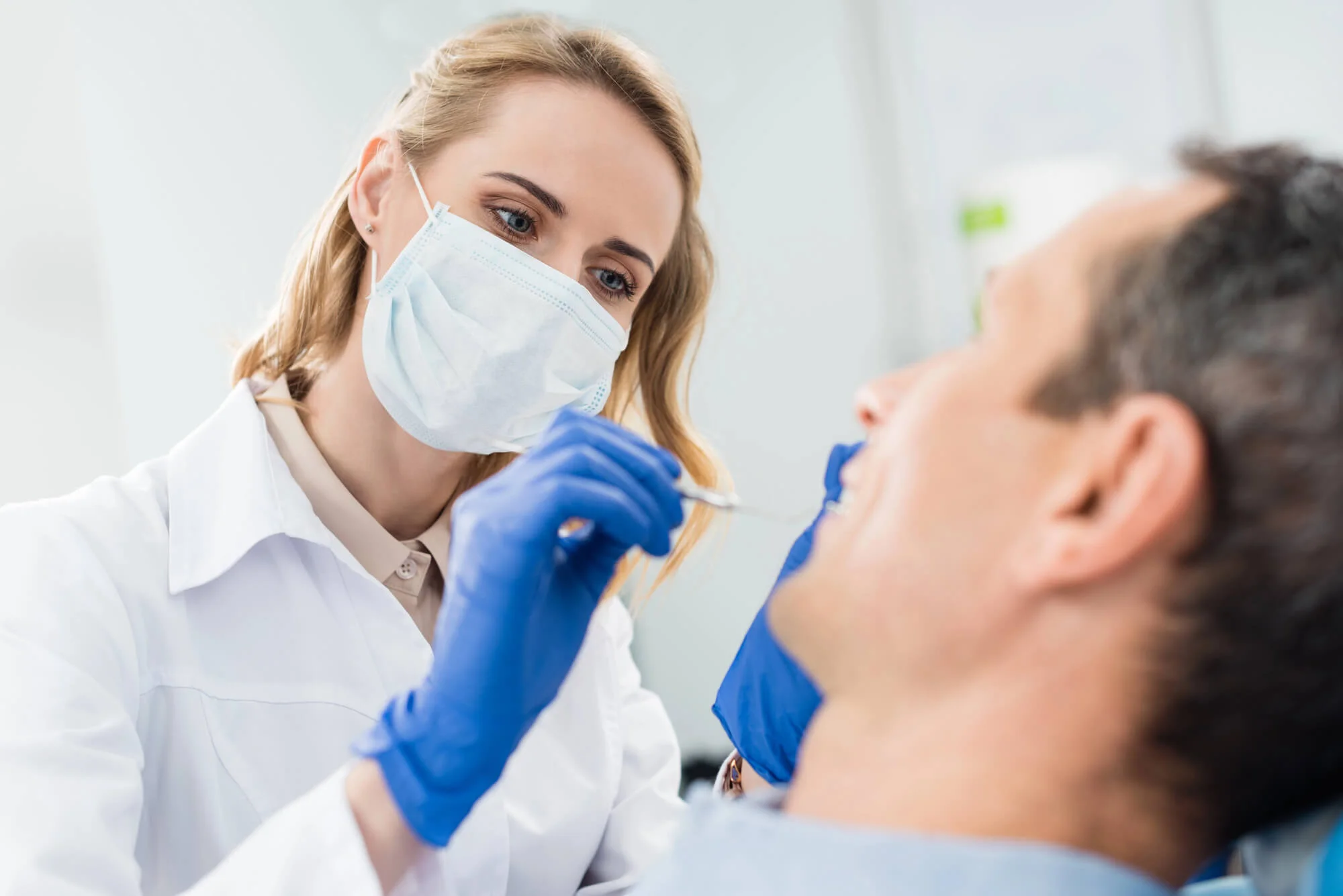 Orthodontist in Fleming Island, FL checking patient teeth